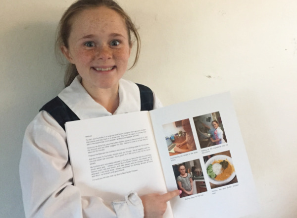 Student writing a family book